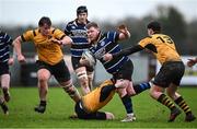 26 January 2025; Ben McGuinness of Wexford Wanderers is tackled by Cathal Bradley, left, and Conor Delaney of Ashbourne during the Bank of Ireland Provincial Towns Cup Round 1 match between Ashbourne RFC and Wexford Wanderers RFC at Milltown House in Ashbourne, Meath. Photo by Seb Daly/Sportsfile