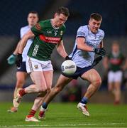 25 January 2025; Matthew Ruane of Mayo races clear of Greg McEneaney of Dublin during the Allianz Football League Division 1 match between Dublin and Mayo at Croke Park. Photo by Ray McManus/Sportsfile