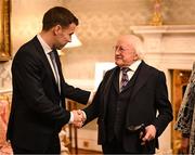 30 January 2025; President of Ireland Michael D. Higgins with Republic of Ireland captain Séamus Coleman before receiving a Presidential Distinguished Service Award for the Irish Abroad at Áras an Uachtaráin in Dublin. The Awards recognise the service given to this country or to Irish communities abroad by those who live outside Ireland. Photo by Stephen McCarthy/Sportsfile