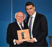 30 January 2025; President of Ireland Michael D. Higgins presents a Presidential Distinguished Service Award for the Irish Abroad to Republic of Ireland captain Séamus Coleman at Áras an Uachtaráin in Dublin. The Awards recognise the service given to this country or to Irish communities abroad by those who live outside Ireland. Photo by Stephen McCarthy/Sportsfile