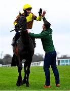 1 February 2025; Paul Townend celebrates on Galopin Des Champs, along with groom Adam Connolly, after winning The Paddy Power Irish Gold Cup during day one of the Dublin Racing Festival at Leopardstown Racecourse in Dublin. Photo by Shauna Clinton/Sportsfile