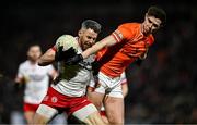 1 February 2025; Mattie Donnelly of Tyrone is tackled by Ben Crealey of Armagh during the Allianz Football League Division 1 match between Armagh and Tyrone at BOX-IT Athletic Grounds in Armagh. Photo by Ben McShane/Sportsfile