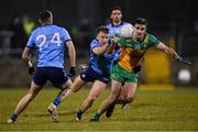 1 February 2025; Caolan McGonagle of Donegal is tackled by Seán Bugler of Dublin during the Allianz Football League Division 1 match between Donegal and Dublin at MacCumhaill Park in Ballybofey, Donegal. Photo by Stephen McCarthy/Sportsfile