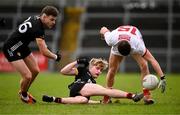 2 February 2025; Sean McDonnell of Cork in action against Ryan Magill, left, and Paddy McCarthy of Down during the Allianz Football League Division 2 match between Down and Cork at Páirc Esler in Newry, Down. Photo by Ramsey Cardy/Sportsfile