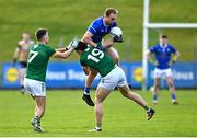2 February 2025; Padraig Faulkner of Cavan is tackled by Ronan Jones of Meath as Ciarán Caulfield of Meath watches on during the Allianz Football League Division 2 match between Meath and Cavan at Páirc Tailteann in Navan, Meath. Photo by Tyler Miller/Sportsfile