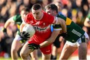 2 February 2025; Niall Toner of Derry is tackled by Graham O'Sullivan of Kerry during the Allianz Football League Division 1 match between Derry and Kerry at Celtic Park in Derry. Photo by Stephen McCarthy/Sportsfile