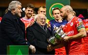 7 February 2025; President of Ireland Michael D Higgins and FAI President Paul Cooke, left, present the FAI President's Cup to Shelbourne captain Mark Coyle after the 2025 FAI President's Cup final match between Shelbourne and Drogheda United at Tolka Park in Dublin. Photo by Shauna Clinton/Sportsfile
