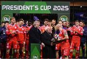 7 February 2025; President of Ireland Michael D Higgins, in the company of FAI President Paul Cooke hands the FAI President's Cup over to winning Shelbourne captain Mark Coyle after the 2025 Men's FAI President's Cup final match between Shelbourne and Drogheda United at Tolka Park in Dublin. Photo by Stephen McCarthy/Sportsfile