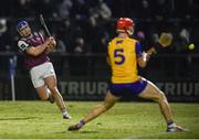 8 February 2025; Anthony Burns of Galway shoots to score his side's first goal despite the efforts of Darragh Lohan of Clare during the Allianz Hurling League Division 1A match between Galway and Clare at Pearse Stadium in Galway. Photo by John Sheridan/Sportsfile
