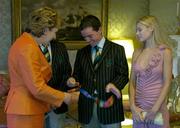 1 September 2004; President of Ireland, Mary McAleese is shown the Gold Medal won by Irish showjumper Cian O'Connor, 2nd from right, in the company of his girlfriend Rachel Wise and Irish Chef de Mission Willie O'Brien, hidden, at a reception, held in Aras an Uachtarain, in honour of the Irish Olympic team's achievements at the 2004 Olympic Games in Athens recently. Picture credit; Brendan Moran / SPORTSFILE