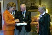 1 September 2004; President of Ireland, Mary McAleese is presented with a momento of Athens 2004 Olympic Games by Pat Hickey, President of the Olympic Council of Ireland, in the company of Irish Chef de Mission Willie O'Brien and Sylviana Hickey, at a reception, held in Aras an Uachtarain, in honour of the Irish Olympic team's achievements at the 2004 Olympic Games in Athens recently. Picture credit; Brendan Moran / SPORTSFILE