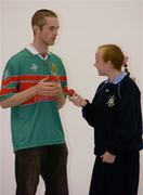 7 September 2004; All-Ireland Handball finalist Joe McCann, Mayo, gives some tips to Kym Ni Bhroin, from Scoil an tSeachtar Laoca, Ballymun, Dublin, at a photocall to announce a new sponsorship deal between the Irish Handball Council and Coca-Cola. In an exciting new Coca Cola &quot;Play It&quot; initiative, it offers football and hurling fans the first ever opportunity to play at Croke Park on All-Ireland days. The Croke Park Handball Centre will open up for fans from 12 noon to 2.30pm on All-Ireland FInal days for those wishing to try their hand at the game. The deal will also see the company sponsor the 2004 All-Ireland 60 x 30 Handball Championship Finals on Saturday 11th and 25th September. Croke Park, Dublin. Picture credit; Brendan Moran / SPORTSFILE