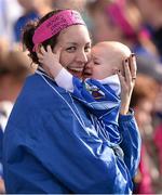 29 September 2013; Clare O'Reilly, from Ballyjamesduff, Co. Cavan, protects her son Paul from noise of the celebrating fans. TG4 All-Ireland Ladies Football Interrmediate Championship Final, Cavan v Tipperary, Croke Park, Dublin. Picture credit: Ray McManus / SPORTSFILE