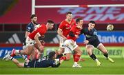 15 February 2025; Billy Burns of Munster in action against Scarlets players Steff Evans, left, and Joe Roberts during the United Rugby Championship match between Munster and Scarlets at Thomond Park in Limerick. Photo by Seb Daly/Sportsfile