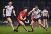 15 February 2025; Ethan Doherty of Derry in action against Dylan McHugh of Galway during the Allianz Football League Division 1 match between Derry and Galway at Celtic Park in Derry. Photo by Ramsey Cardy/Sportsfile