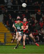 15 February 2025; Seamus Lavin of Meath in action against James Guinness of Down during the Allianz Football League Division 2 match between Down and Meath at Páirc Esler in Newry, Down. Photo by Stephen Marken/Sportsfile