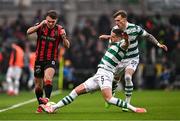16 February 2025; Dayle Rooney of Bohemians in action against Lee Grace, 5, and Danny Grant of Shamrock Rovers during the SSE Airtricity Men's Premier Division match between Bohemians and Shamrock Rovers at the Aviva Stadium in Dublin. Photo by Ben McShane/Sportsfile