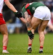 16 February 2025; Jordan Flynn of Mayo holds his leg as he shakes hands with Michael McKernan of Tyrone during the Allianz Football League Division 1 match between Mayo and Tyrone at Hastings Insurance MacHale Park in Castlebar, Mayo. Photo by Piaras Ó Mídheach/Sportsfile