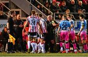21 February 2025; Referee Marc Lynch, centre, attempts to separate the dispute between each team's respective bench before issuing a red card to Bohemians manager Alan Reynolds, left, and Derry City manager Tiernan Lynch, hidden, during the SSE Airtricity Men's Premier Division match between Derry City and Bohemians at The Ryan McBride Brandywell Stadium in Derry. Photo by Shauna Clinton/Sportsfile