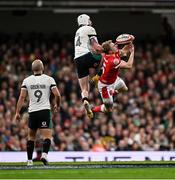 22 February 2025; Mack Hansen of Ireland and Blair Murray of Wales contest a high ball during the Guinness Six Nations Rugby Championship match between Wales and Ireland at the Principality Stadium in Cardiff, Wales. Photo by Seb Daly/Sportsfile