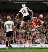 22 February 2025; Mack Hansen of Ireland and Blair Murray of Wales contest a high ball during the Guinness Six Nations Rugby Championship match between Wales and Ireland at the Principality Stadium in Cardiff, Wales. Photo by Seb Daly/Sportsfile