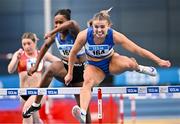 22 February 2025; Molly Scott of St Laurence O'Toole AC, Carlow, right, on her way to winning her women's 60m hurdles heat during day one of the 123.ie National Senior Indoor Championships at the National Indoor Arena on the Sport Ireland Campus in Dublin. Photo by Sam Barnes/Sportsfile