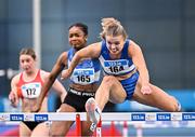 22 February 2025; Molly Scott of St Laurence O'Toole AC, Carlow, right, on her way to winning her women's 60m hurdles heat during day one of the 123.ie National Senior Indoor Championships at the National Indoor Arena on the Sport Ireland Campus in Dublin. Photo by Sam Barnes/Sportsfile