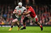 22 February 2025; Mack Hansen of Ireland is tackled by Taulupe Faletau of Wales during the Guinness Six Nations Rugby Championship match between Wales and Ireland at the Principality Stadium in Cardiff, Wales. Photo by Ben McShane/Sportsfile