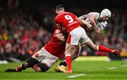 22 February 2025; Mack Hansen of Ireland is tackled by Taulupe Faletau, left, and Tomos Williams of Wales during the Guinness Six Nations Rugby Championship match between Wales and Ireland at the Principality Stadium in Cardiff, Wales. Photo by Ben McShane/Sportsfile
