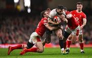 22 February 2025; Robbie Henshaw of Ireland is tackled by Max Llewellyn, left, and Elliot Dee of Wales during the Guinness Six Nations Rugby Championship match between Wales and Ireland at the Principality Stadium in Cardiff, Wales. Photo by Ben McShane/Sportsfile