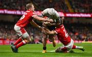 22 February 2025; Mack Hansen of Ireland is tackled by Blair Murray, left, and Joe Roberts of Wales during the Guinness Six Nations Rugby Championship match between Wales and Ireland at the Principality Stadium in Cardiff, Wales. Photo by Ben McShane/Sportsfile