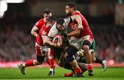 22 February 2025; Robbie Henshaw of Ireland is tackled by Wales players, from left, Elliot Dee, Ben Thomas and Taulupe Faletau during the Guinness Six Nations Rugby Championship match between Wales and Ireland at the Principality Stadium in Cardiff, Wales. Photo by Ben McShane/Sportsfile
