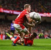 22 February 2025; Mack Hansen of Ireland is tackled by Blair Murray, 15, and Joe Roberts of Wales during the Guinness Six Nations Rugby Championship match between Wales and Ireland at the Principality Stadium in Cardiff, Wales. Photo by Ben McShane/Sportsfile