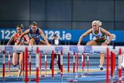 22 February 2025; Sarah Lavin of Emerald AC, Limerick, right, on her way to winning the women's 60m hurdles final ahead of Molly Scott of St Laurence O'Toole AC, Carlow, left, who finished second,  during day one of the 123.ie National Senior Indoor Championships at the National Indoor Arena on the Sport Ireland Campus in Dublin. Photo by Sam Barnes/Sportsfile