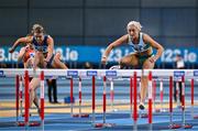 22 February 2025; Sarah Lavin of Emerald AC, Limerick, right, on her way to winning the women's 60m hurdles final ahead of Molly Scott of St Laurence O'Toole AC, Carlow, left, who finished second,  during day one of the 123.ie National Senior Indoor Championships at the National Indoor Arena on the Sport Ireland Campus in Dublin. Photo by Sam Barnes/Sportsfile