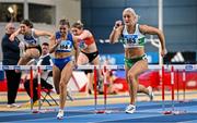 22 February 2025; Sarah Lavin of Emerald AC, Limerick, right, on her way to winning the women's 60m hurdles final ahead of Molly Scott of St Laurence O'Toole AC, Carlow, left, who finished second,  during day one of the 123.ie National Senior Indoor Championships at the National Indoor Arena on the Sport Ireland Campus in Dublin. Photo by Sam Barnes/Sportsfile