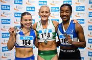 22 February 2025; Women's 60m hurdles medallists, Sarah Lavin of Emerald AC, Limerick, gold, centre, Molly Scott of St Laurence O'Toole AC, Carlow, silver, left, and Arabella Adekoya of St Laurence O'Toole AC, Carlow, bronze, right,during day one of the 123.ie National Senior Indoor Championships at the National Indoor Arena on the Sport Ireland Campus in Dublin. Photo by Sam Barnes/Sportsfile