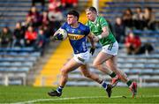22 February 2025; Cathal Deeley of Tipperary is tackled by  Paddy Dolan of London during the Allianz Football League Division 4 match between Tipperary and London at FBD Semple Stadium in Thurles, Tipperary. Photo by Brendan Moran/Sportsfile