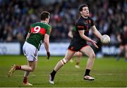 22 February 2025; Jarly Óg Burns of Armagh in action against Matthew Ruane of Mayo during the Allianz Football League Division 1 match between Armagh and Mayo at the BOX-IT Athletic Grounds in Armagh. Photo by David Fitzgerald/Sportsfile