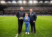 22 February 2025; Layla Quinn, St Eithne’s GNS, Edenmore, with Damian Bradfield, Customer Relationship Executive Allianz, left, and James Hayden, Chairman, Cumann na mBunscol, during half-time of the Allianz Football League Division 1 match between Dublin and Derry at Croke Park in Dublin. Photo by Piaras Ó Mídheach/Sportsfile