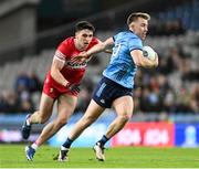 22 February 2025; Seán Bugler of Dublin in action against Ben McCarron of Derry during the Allianz Football League Division 1 match between Dublin and Derry at Croke Park in Dublin. Photo by Daire Brennan/Sportsfile