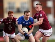 23 February 2025; Gearoid McKiernan of Cavan in action against  Westmeath players, from left, Ronan Wallace and Conor Dillon during the Allianz Football League Division 2 match between Westmeath and Cavan at TEG Cusack Park in Mullingar, Westmeath. Photo by Michael P Ryan/Sportsfile