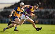 23 February 2025; Conor Foley of Wexford in action against Aidan McCarthy of Clare during the Allianz Hurling League Division 1A match between Clare and Wexford at Cusack Park in Ennis, Clare. Photo by Brendan Moran/Sportsfile