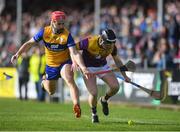 23 February 2025; Darragh Lohan of Clare in action against Cian Byrne of Wexford during the Allianz Hurling League Division 1A match between Clare and Wexford at Cusack Park in Ennis, Clare. Photo by John Sheridan/Sportsfile