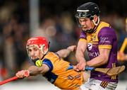 23 February 2025; Cian Byrne of Wexford in action against Darragh Lohan of Clare during the Allianz Hurling League Division 1A match between Clare and Wexford at Cusack Park in Ennis, Clare. Photo by Brendan Moran/Sportsfile