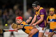 23 February 2025; Cian Byrne of Wexford in action against Darragh Lohan of Clare during the Allianz Hurling League Division 1A match between Clare and Wexford at Cusack Park in Ennis, Clare. Photo by Brendan Moran/Sportsfile