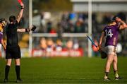 23 February 2025; Cian Byrne of Wexford is shown a red card by referee Thomas Gleeson during the Allianz Hurling League Division 1A match between Clare and Wexford at Cusack Park in Ennis, Clare. Photo by Brendan Moran/Sportsfile