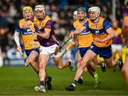 23 February 2025; Cathal Dunbar of Wexford in action against Paddy Donnellan and Cian Galvin of Clare during the Allianz Hurling League Division 1A match between Clare and Wexford at Cusack Park in Ennis, Clare. Photo by Brendan Moran/Sportsfile