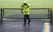 23 February 2025; Steward Mickey Daly heads for shelter after closing the pitch gate after players and officials walked the pitch before the Allianz Football League Division 1 match between Galway and Donegal at Pearse Stadium in Galway. Photo by Piaras Ó Mídheach/Sportsfile