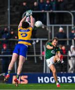 23 February 2025; Shane Walsh of Meath kicks a point despite the efforts of Keith Doyle of Roscommon during the Allianz Football League Division 2 match between Meath and Roscommon at Páirc Tailteann in Navan, Meath. Photo by Shauna Clinton/Sportsfile